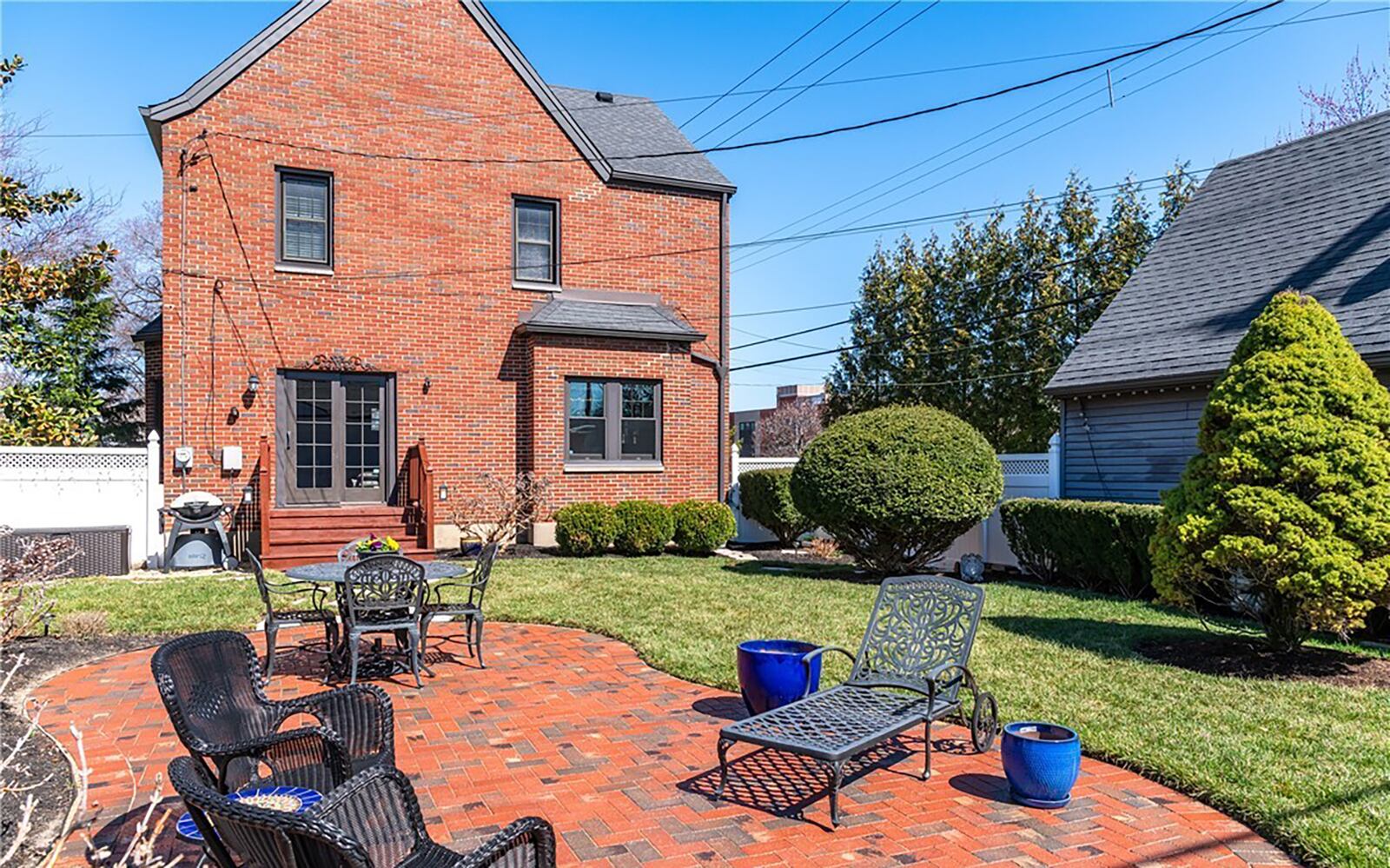 The backyard is a haven with brick paver patio and extensive landscaping with a vinyl privacy fence.