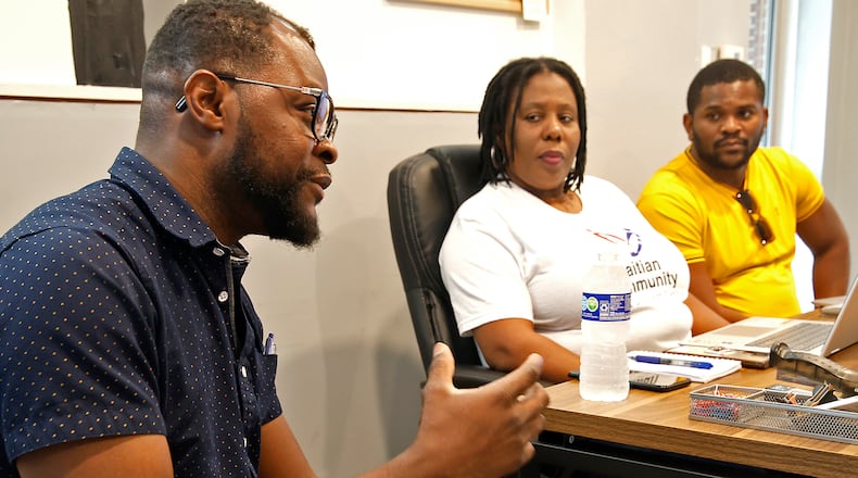 Viles Dorsainvil, left, talks about the Haitian Community Center, with fellow board members, Rose Thamar Joseph and Lindsay Aime Wednesday, June 5, 2024 at the community center on South Yellow Springs Street. BILL LACKEY/STAFF