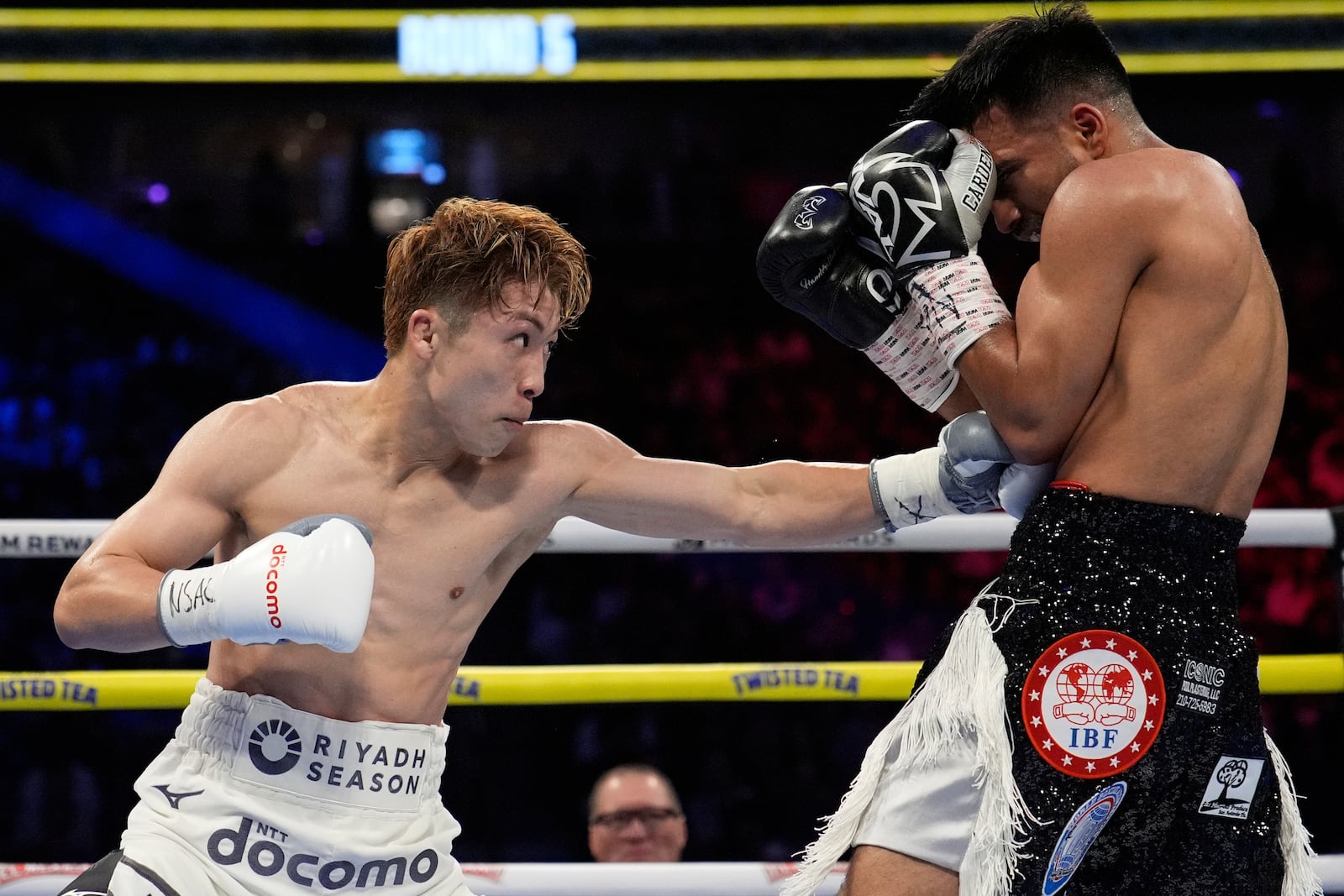 Naoya Inoue hits Ramon Cardenas in a junior featherweight title boxing match Sunday, May 4, 2025, in Las Vegas. (AP Photo/John Locher)