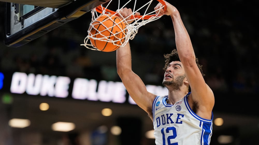 Duke forward Cameron Boozer dunks against TCU during the second half in the second round of the NCAA college basketball tournament, Saturday, March 21, 2026, in Greenville, S.C. (AP Photo/Chris Carlson)