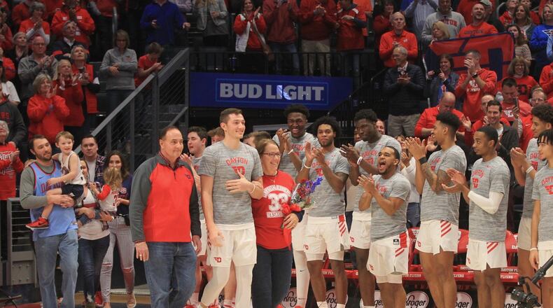 Dayton’s Ryan Mikesell walks onto the court on Senior Night with his parents Reed and Lisa on Saturday, March 7, 2020, at UD Arena. David Jablonski/Staff