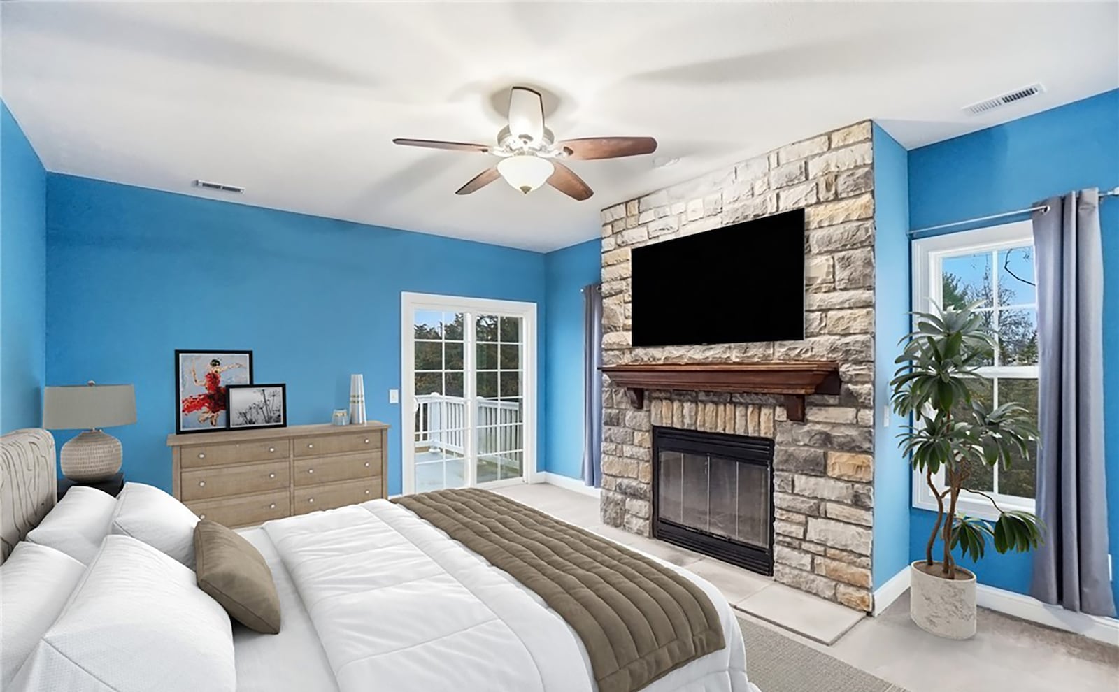 The primary bedroom suite has carpeting, a stacked stone fireplace, ceiling fan, ensuite bathroom and private second floor balcony. CONTRIBUTED