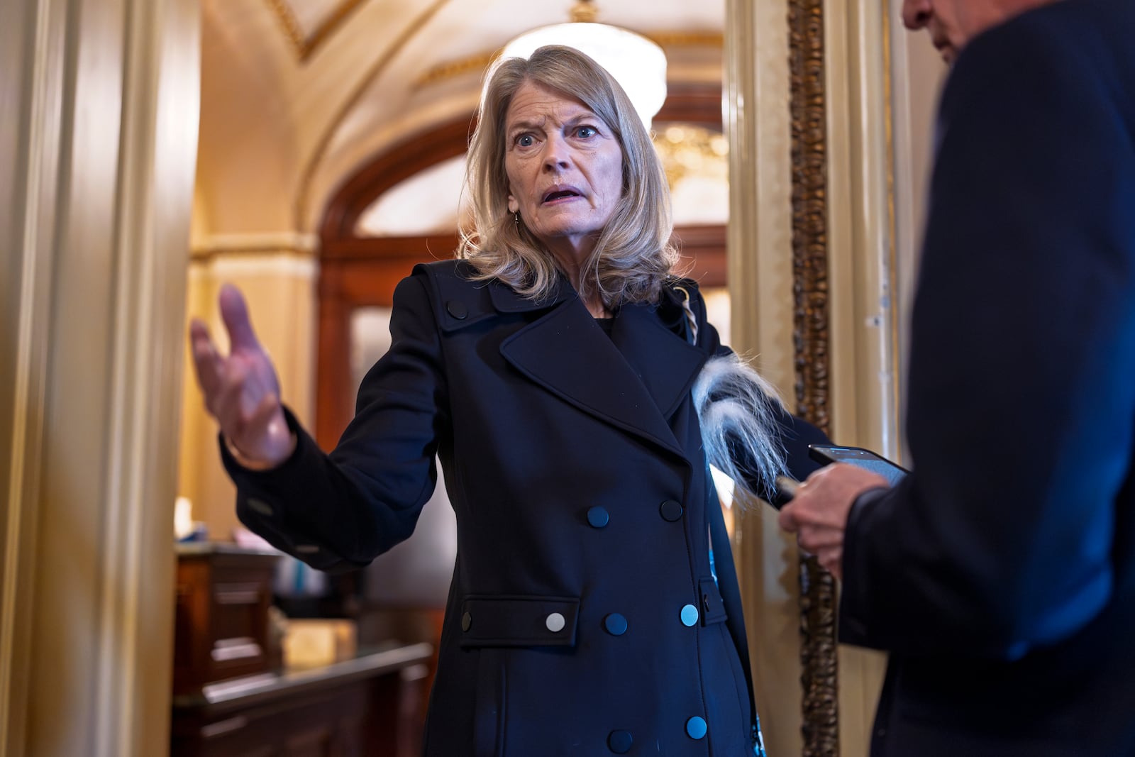 FILE - Sen. Lisa Murkowski, R-Alaska, a member of the Senate Appropriations Committee, pauses outside the chamber to answer a question from a reporter at the Capitol in Washington, March 14, 2025. (AP Photo/J. Scott Applewhite, File)