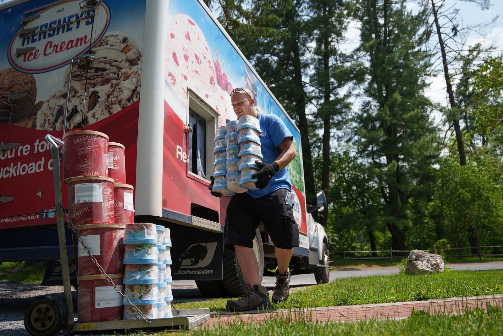Hershey's Ice Cream delivery driver Sam Sattazahn delivers ice cream to Pine Grove Furnace general store, home of the half-gallon ice cream challenge, at Pine Grove Furnace State Park in Pennsylvania on Tuesday, June 10, 2025.(AP Photo/Mingson Lau)