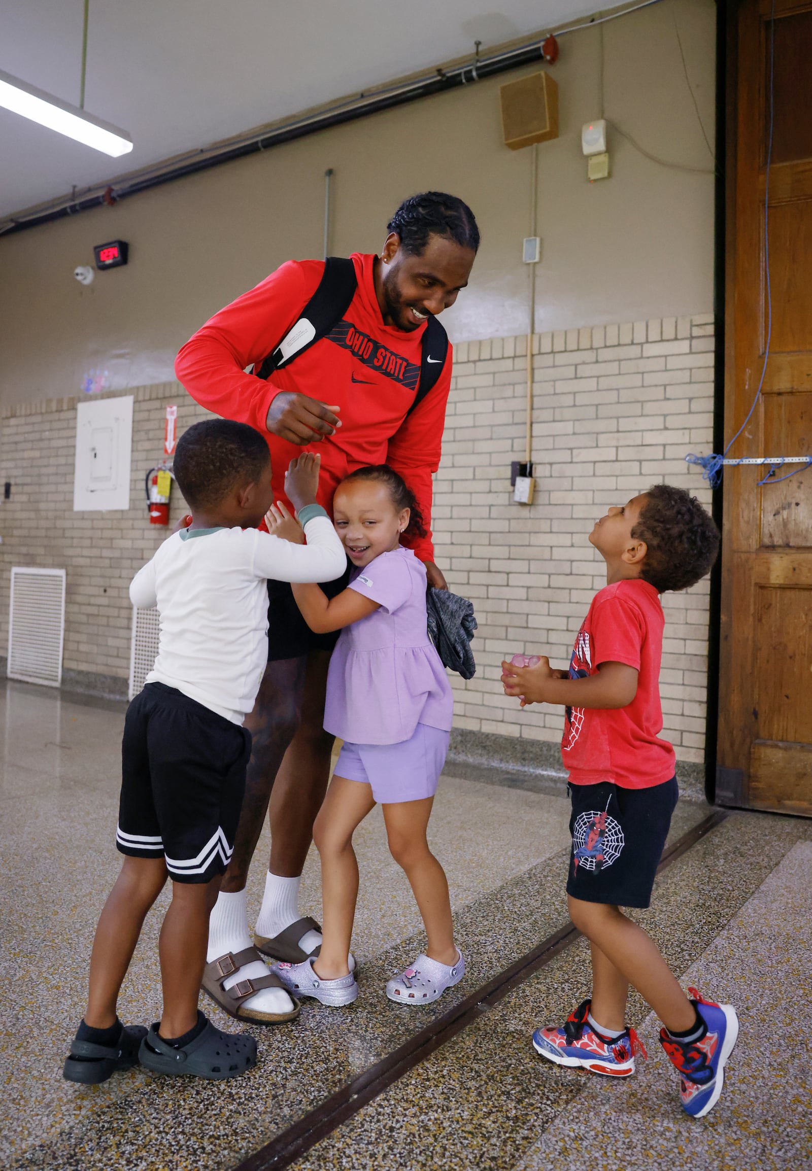 Former Ohio State quarterback and wide receiver Braxton Miller greets young kids on Tuesday, July 1, 2025, at the Springfield Sports Academy. JOSEPH COOKE/STAFF