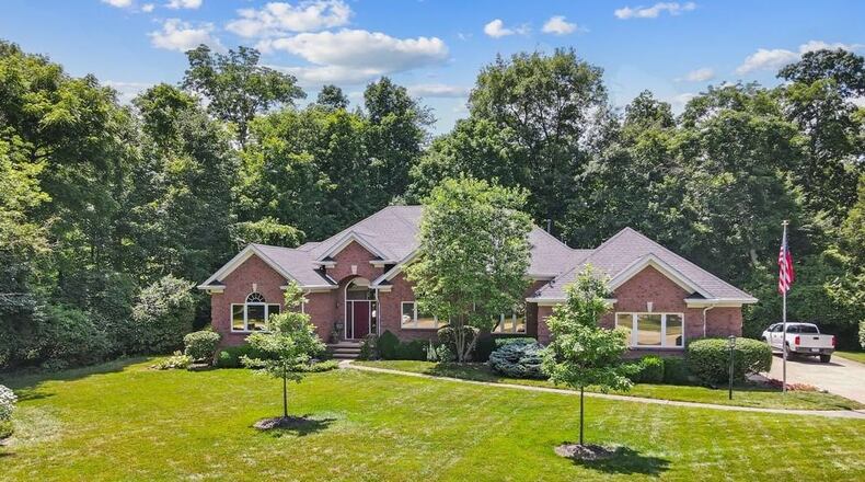 The custom built three bedroom brick ranch has a finished basement and a wooded one acre lot.