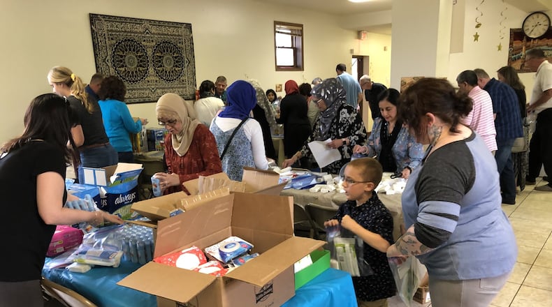 Members of the Muslim and Christian communities got together to create 500 packs of food and personal hygiene items to donate to the Springfield Soup Kitchen on Sunday, May 19. Photo by Brett Turner