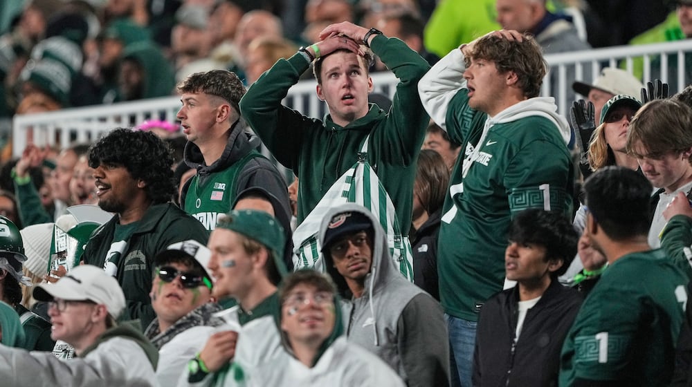 Michigan State fans react during the first half of an NCAA college football game against Michigan Saturday, Oct. 25, 2025, in East Lansing, Mich. (AP Photo/Ryan Sun)