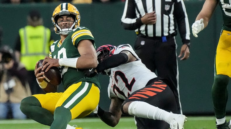Cincinnati Bengals safety Geno Stone (22) sacks Green Bay Packers quarterback Jordan Love (10) in the second half of an NFL football game, Sunday, Oct. 12, 2025, in Green Bay, Wis. (AP Photo/Morry Gash)