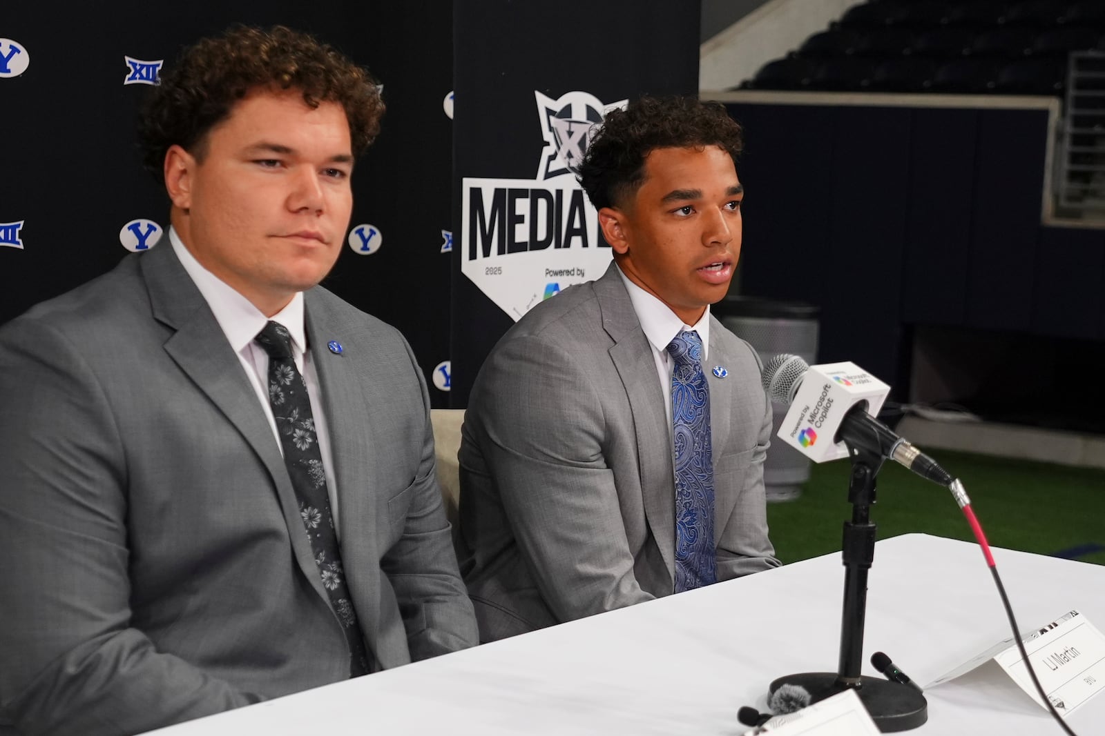 BYU running back LJ Martin, right, speaks as teammate defensive lineman Keanu Tanuvasa looks on during the Big 12 NCAA college football media days in Frisco, Texas, Tuesday, July 8, 2025. (AP Photo/LM Otero)