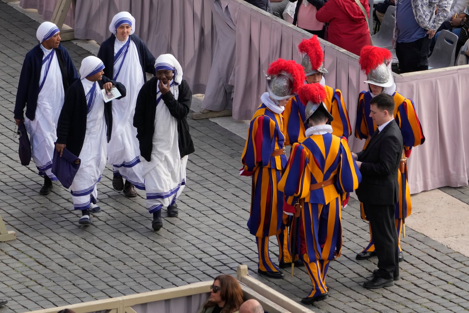 Missionaries of Charity nuns arrive for the Easter mass in St. Peter's Square at the Vatican Sunday, April 20, 2025. (AP Photo/Gregorio Borgia)