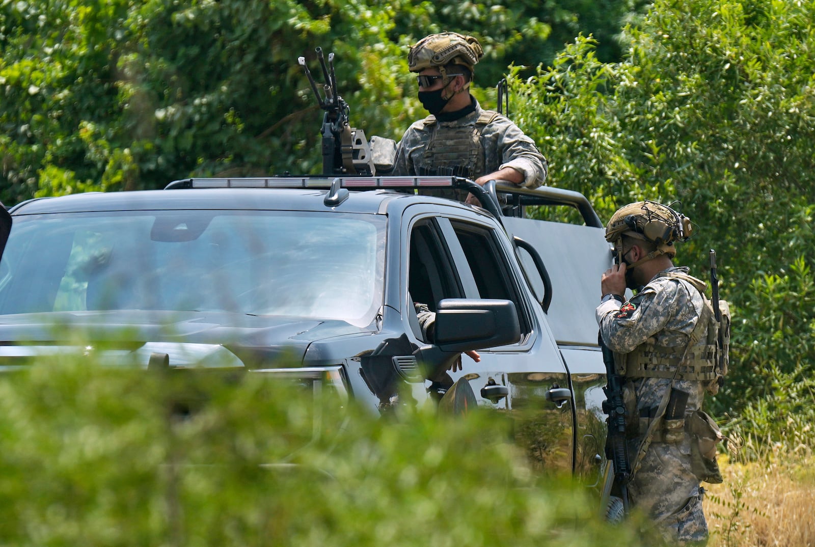 Forces of the regional Kurdish administration secure the area of the Jasana Cave ahead of a symbolic disarmament ceremony by the separatist PKK group as part of the peace process with Turkey, in Sulaymaniyah governorate, Iraq, Friday, July 11, 2025. (AP Photo/Hadi Mizban)