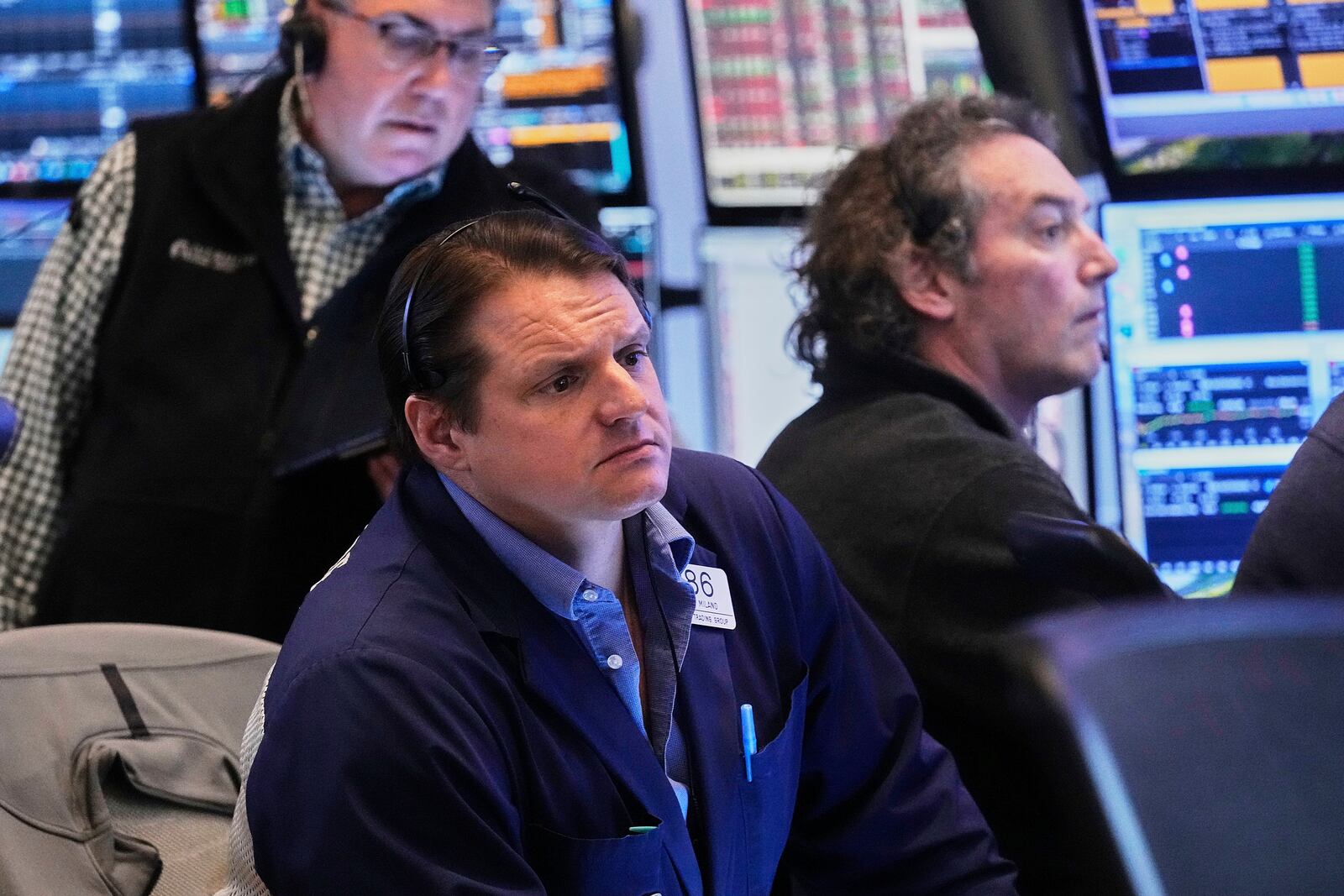 Trader Michael Milano, center, works with colleagues on the floor of the New York Stock Exchange, Friday, April 25, 2025. (AP Photo/Richard Drew)