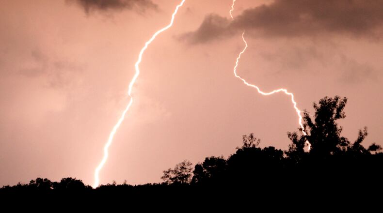 10-4-06--Photo by Ty Greenlees--LIghning strikes in the south part of Greene County on Wednesday eveing. Many people thoughout the Miami Valley were left without power after thunderstorms moved through the area.