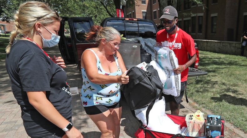 Parents pulled their cars and trucks up to the dorm and upper classman helped freshman move their stuff into their rooms Thursday during Move-In Day at Wittenberg University. BILL LACKEY/STAFF