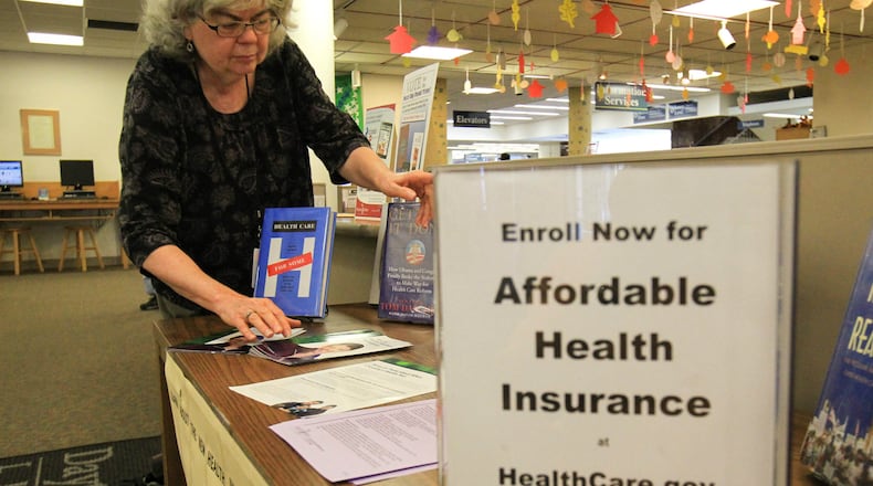Joy Schwaab takes care of providing Affordable Care Act information at the Dayton Metro Library. It's been a bumpy first week - and a somewhat surreal one - for the health care exchanges under the Affordable Care Act, which was at the heart of a partisan dispute that resulted in the first government shutdown in 17 years. The exchange web site had its own shutdown at various points during the weeks as glitches continued to frustrate users. But even as Republican members of Congress sought to delay and defund the law known as Obamacare, people were signing up for coverage. JIM WITMER / STAFF