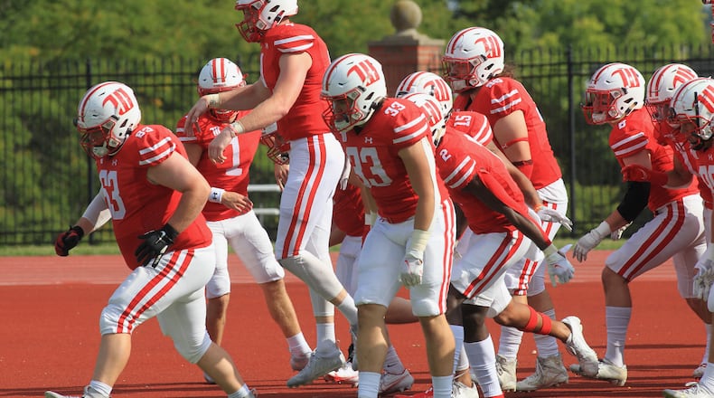 Wittenberg players run onto the field before a game against Hiram on Saturday, Sept. 18, 2021, at Edwards-Maurer Field in Springfield. David Jablonski/Staff