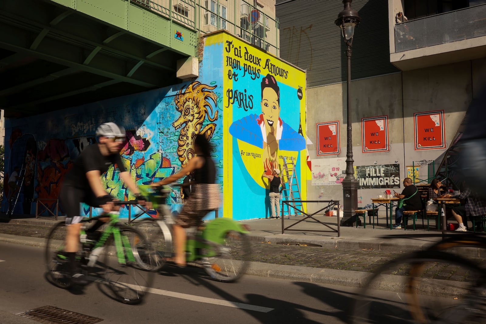 Artist Franck Duval, aka FKDL, works on a mural of U.S.-French entertainer and civil rights activist Josephine Baker in Paris, Saturday, July 19, 2025. (AP Photo/Thomas Padilla)