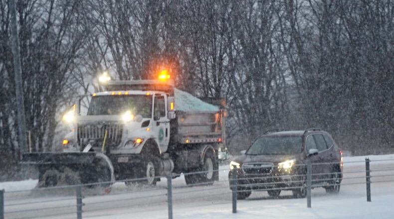 Ohio Department of Transportation (ODOT) trucks plow snow on I-675 near Wilmington Pike, February 16, 2021.