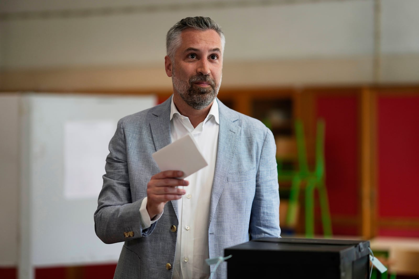Socialist Party secretary general Pedro Nuno Santos holds his ballot when voting in Portugal's general election at a polling station in Lisbon, Sunday, May 18, 2025. (AP Photo/Armando Franca)