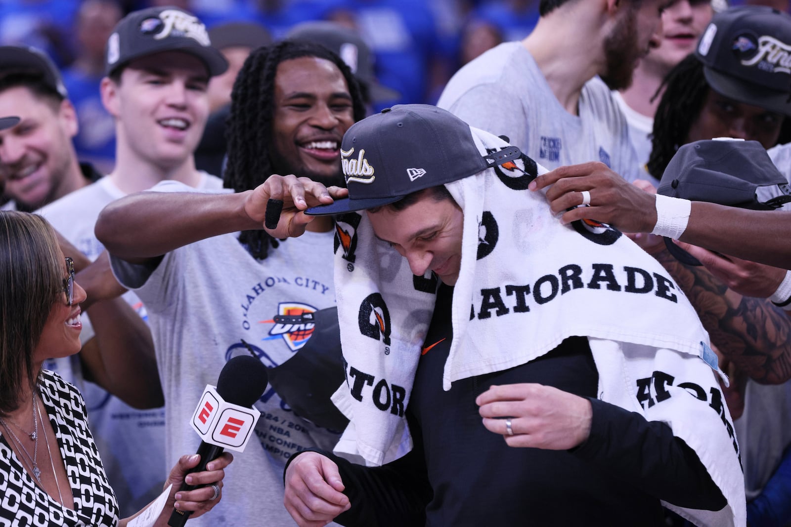 Oklahoma City Thunder head coach Mark Daigneault celebrates with his team after Game 5 of the Western Conference finals of the NBA basketball playoffs against the Minnesota Timberwolves, Wednesday, May 28, 2025, in Oklahoma City. (AP Photo/Nate Billings)