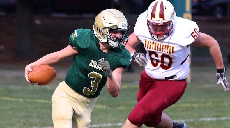 Catholic Central’s Tyler Young tries to avoid Northeastern’s Jordan Hood. BILL LACKEY/STAFF