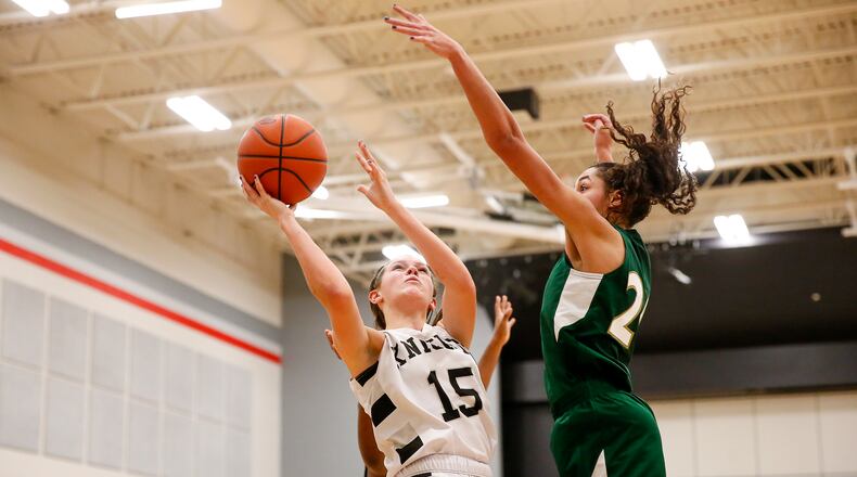 Greenon junior Abby West prepares to shoot the ball as Catholic Central High School senior Mallory Mullen attempts to block her short during their game earlier this season in Enon. CONTRIBUTED PHOTO BY MICHAEL COOPER