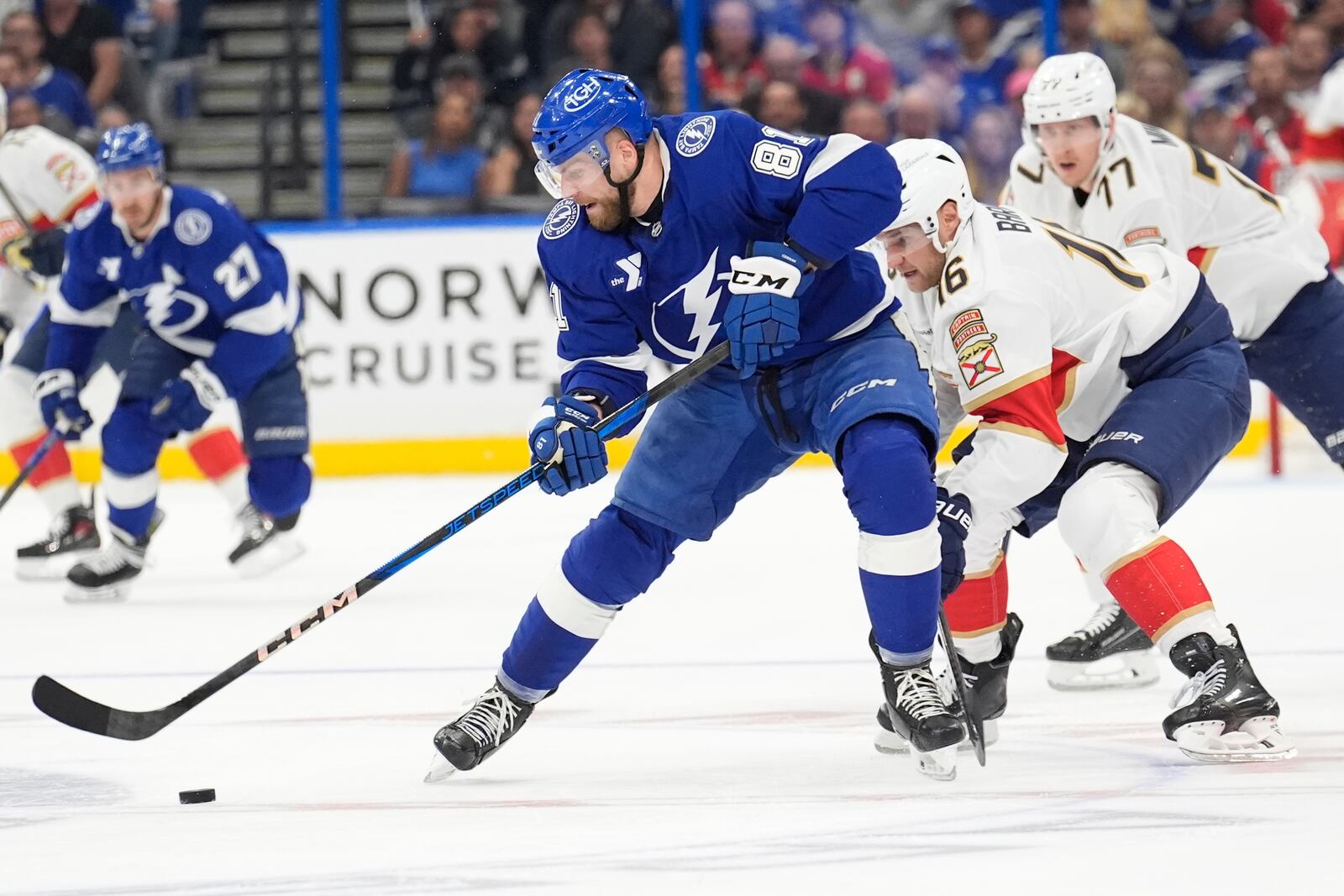 Tampa Bay Lightning defenseman Erik Cernak (81) works the puck in front of Florida Panthers center Aleksander Barkov (16) and defenseman Niko Mikkola (77) during the first period in Game 1 of an NHL hockey Stanley Cup first-round playoff series, Tuesday, April 22, 2025, in Tampa, Fla. (AP Photo/Chris O'Meara)