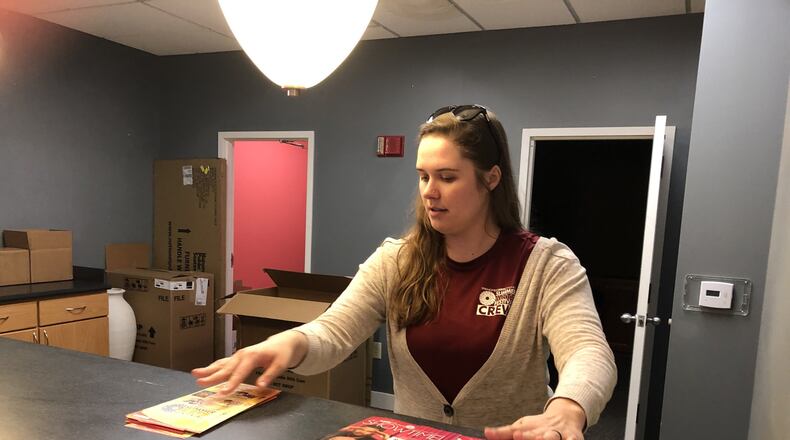 Springfield Arts Council office manager Melanie Ellis puts out marketing materials at the Arts Council’s temporary offices at the Springfield Museum of Art. The Arts Council’s offices at the Heritage Center of Clark County are undergoing restoration after a water pipe burst in April. Photo by Brett Turner