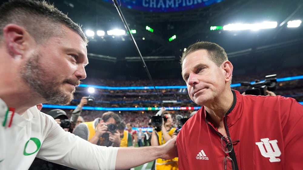 Oregon head coach Dan Lanning, left, greets Indiana head coach Curt Cignetti after the Peach Bowl NCAA college football playoff semifinal, Friday, Jan. 9, 2026, in Atlanta. (AP Photo/Brynn Anderson)