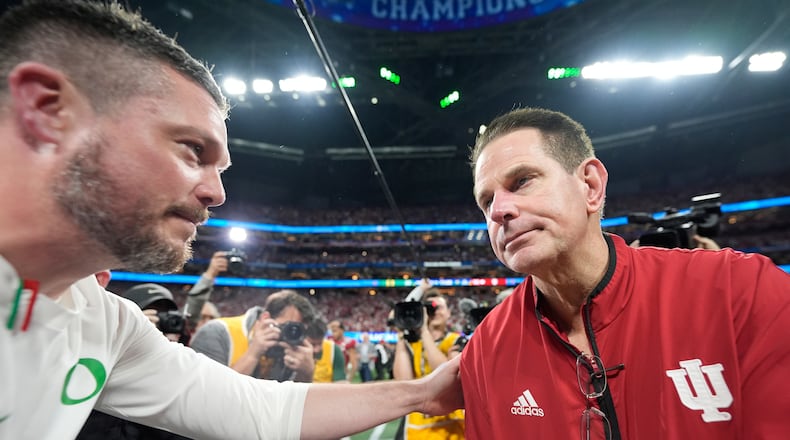 Oregon head coach Dan Lanning, left, greets Indiana head coach Curt Cignetti after the Peach Bowl NCAA college football playoff semifinal, Friday, Jan. 9, 2026, in Atlanta. (AP Photo/Brynn Anderson)