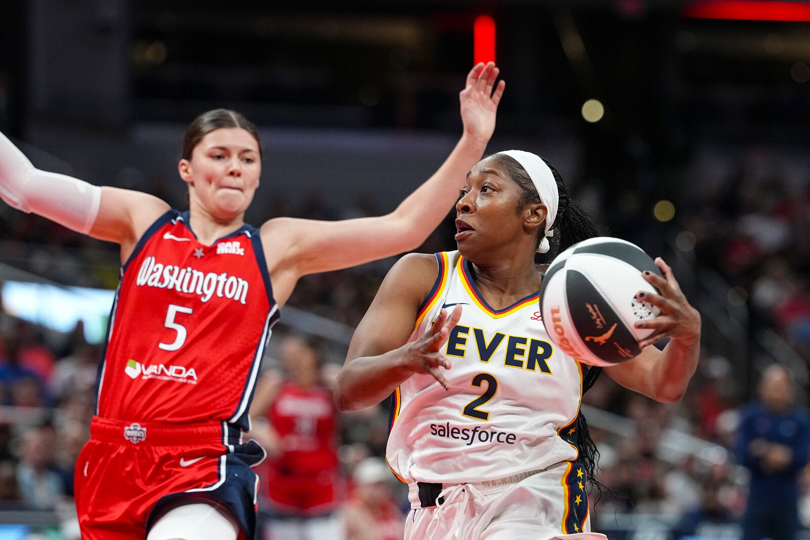 Indiana Fever guard Aari McDonald (2) goes to the basket past Washington Mystics guard Jade Melbourne (5) in the first half of a WNBA basketball game in Indianapolis, Tuesday, June 3, 2025. (AP Photo/Michael Conroy)