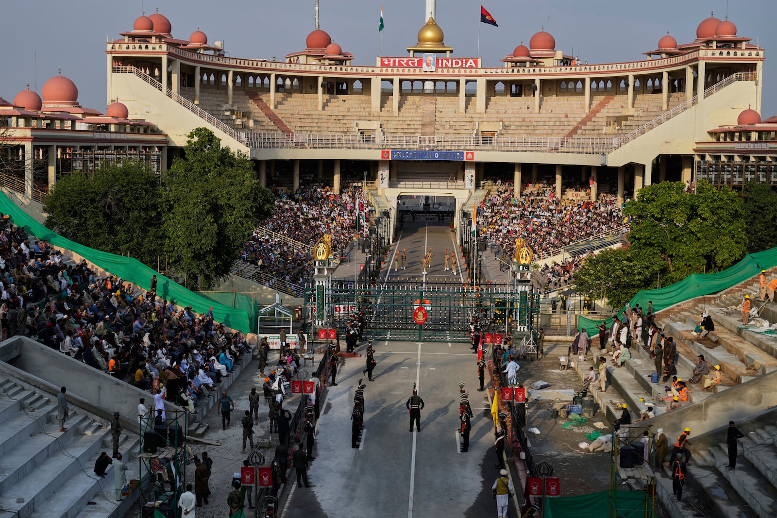 Pakistan's Rangers soldiers, bottom, and Indian Border Security Forces soldiers, top, parade during a daily closing ceremony at the Wagah, a joint post on the Pakistan and India border, near Lahore, Pakistan, Monday, May 5, 2025. (AP Photo/K.M. Chaudary)