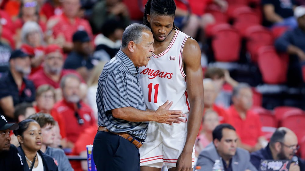 Houston head coach Kelvin Sampson, left, talks with forward Joseph Tugler (11) at the bench during the second half of an NCAA college basketball exhibition game against Mississippi State, Sunday, Oct. 26, 2025, in Rosenberg, Texas. (AP Photo/Michael Wyke)