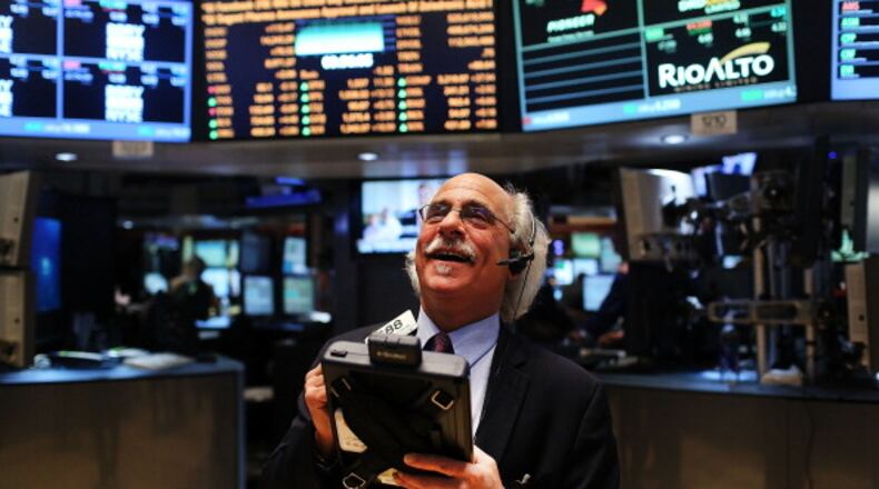 NEW YORK, NY - MARCH 05: Traders work on the floor of The New York Stock Exchange on March 5, 2013 in New York City. The Dow Jones industrial average rallied to a record high on Tuesday to close for the day at 14,253.77, beating its old 2007 record. (Photo by Spencer Platt/Getty Images)