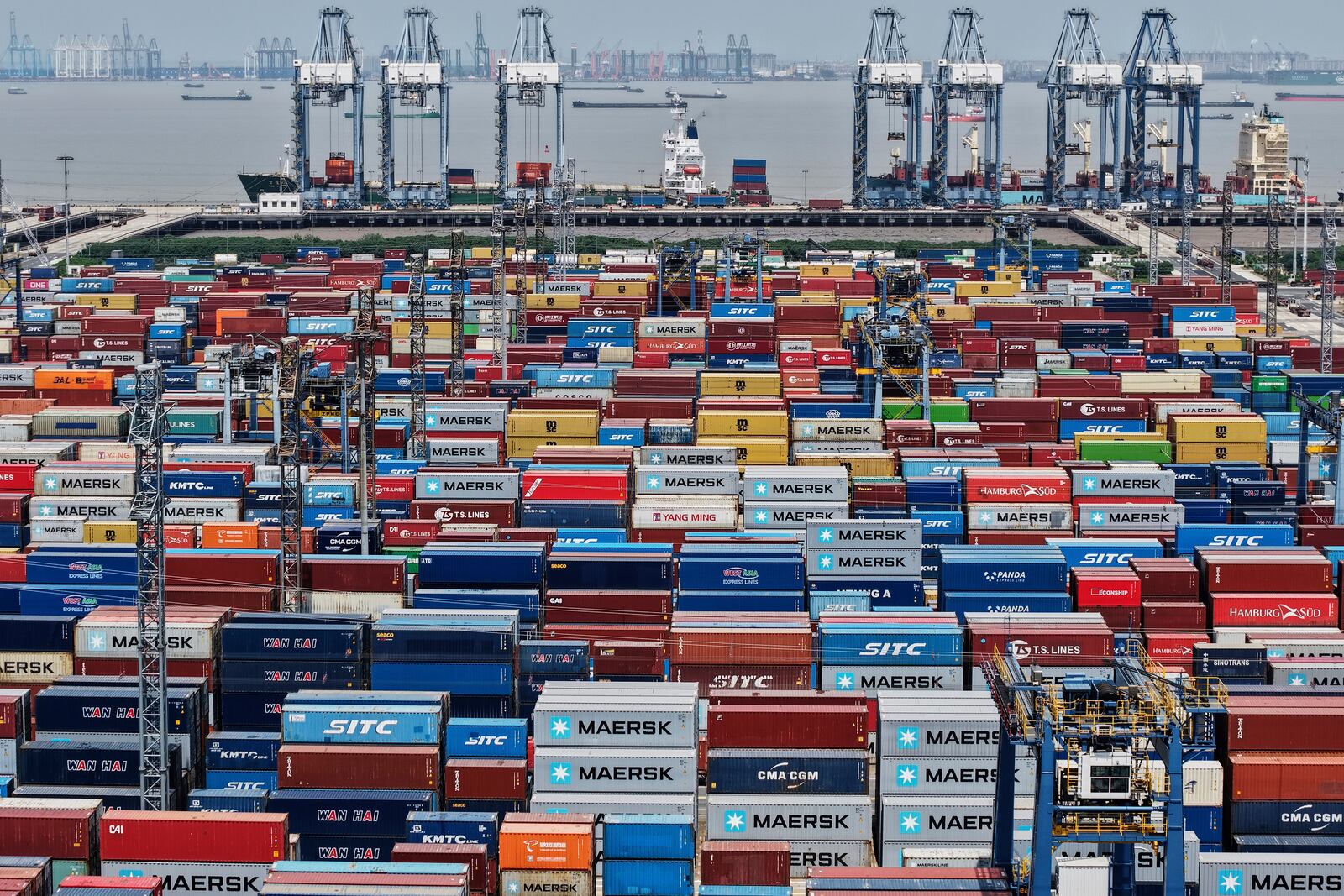 Containers are pile up at a container terminal in Shanghai, China, Sunday, April 20, 2025. (Chinatopix Via AP)