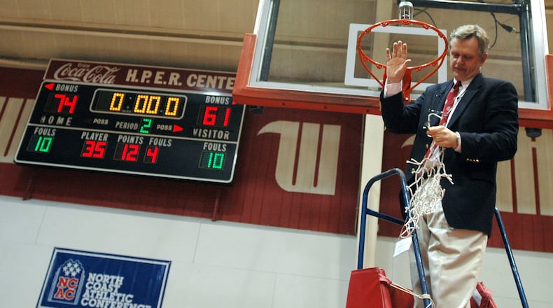 Wittenberg head coach Bill Brown acknowledges the crowd surrounding him as he cuts down the net following a NCAA tournament victory in 2006. (News-Sun photo by Bill Lackey)