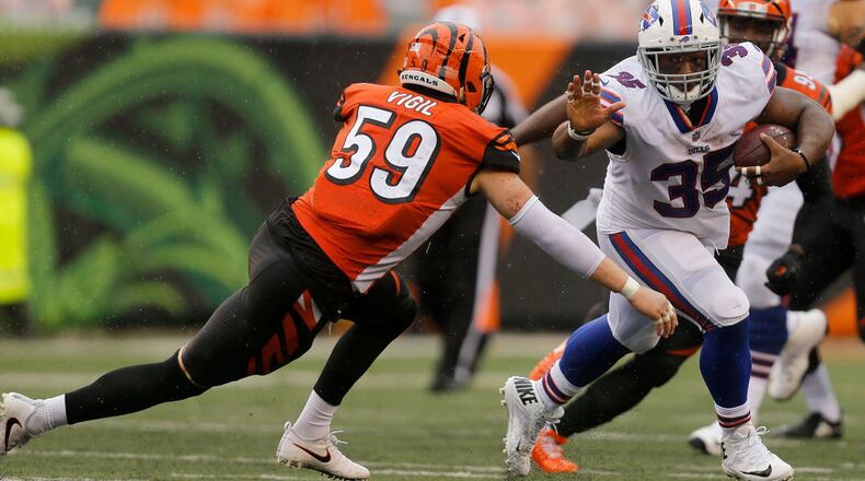 CINCINNATI, OH - OCTOBER 8: Nick Vigil #59 of the Cincinnati Bengals attempts to tackle Mike Tolbert #35 of the Buffalo Bills during the second quarter at Paul Brown Stadium on October 8, 2017 in Cincinnati, Ohio. (Photo by Michael Reaves/Getty Images)