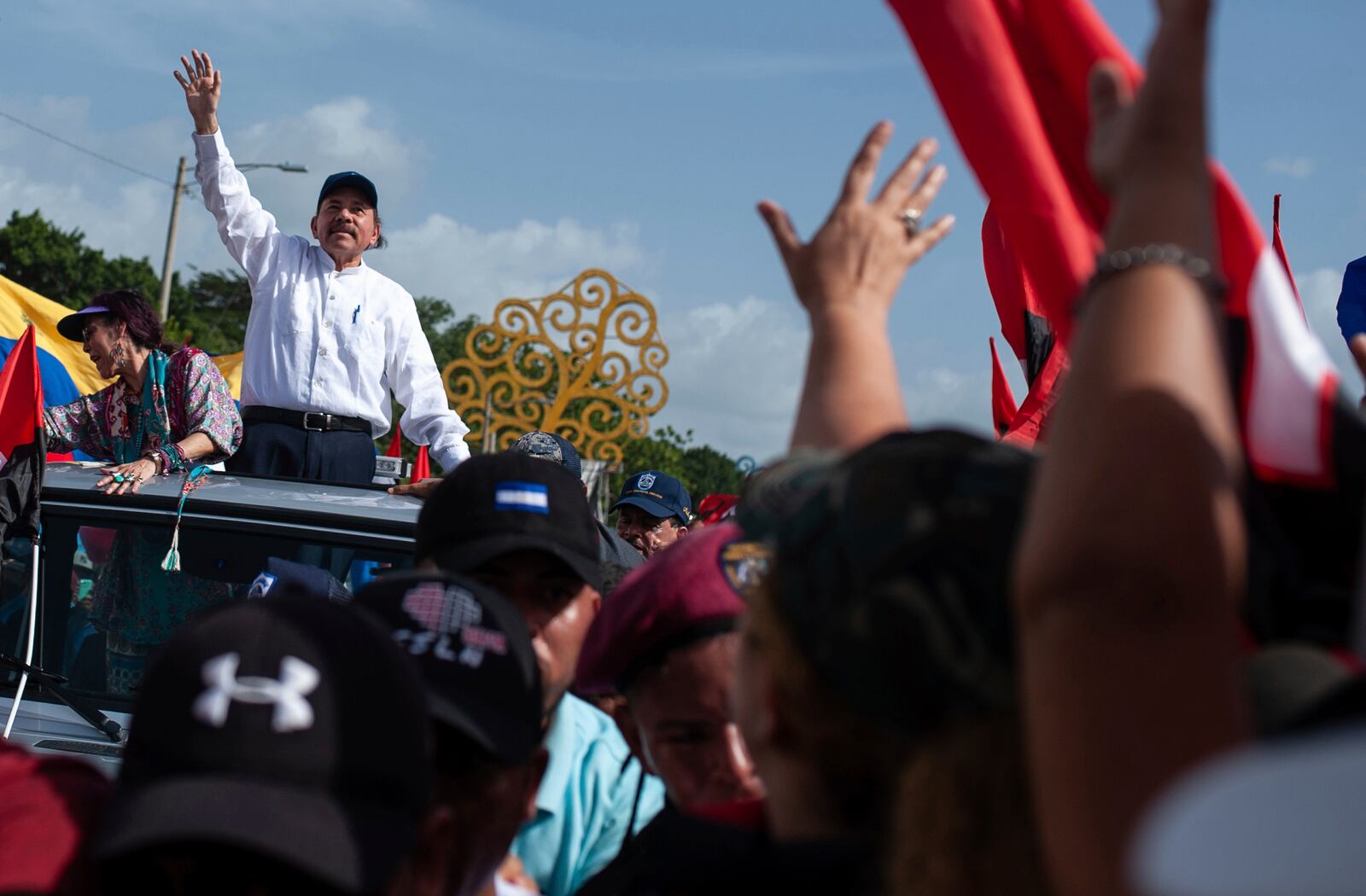 FILE - Nicaraguan President Daniel Ortega and his wife, Vice President Rosario Murillo, arrive at the Juan Pablo II plaza to celebrate the 39th anniversary of the Sandinista revolution, in Managua, Nicaragua, Thursday, July 19, 2018. (AP Photo/Cristobal Venegas, File)