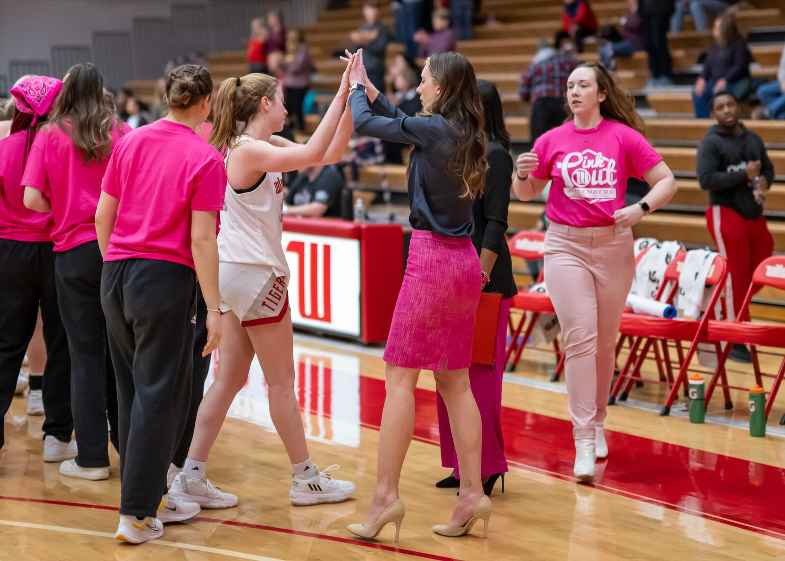 Wittenberg celebrates winning the NCAC regular-season championship on Saturday, Feb. 18, after a victory against Oberlin at Pam Evans Smith Arena in Springfield. At center is coach Melissa Kolbe. Photo by John Coffman