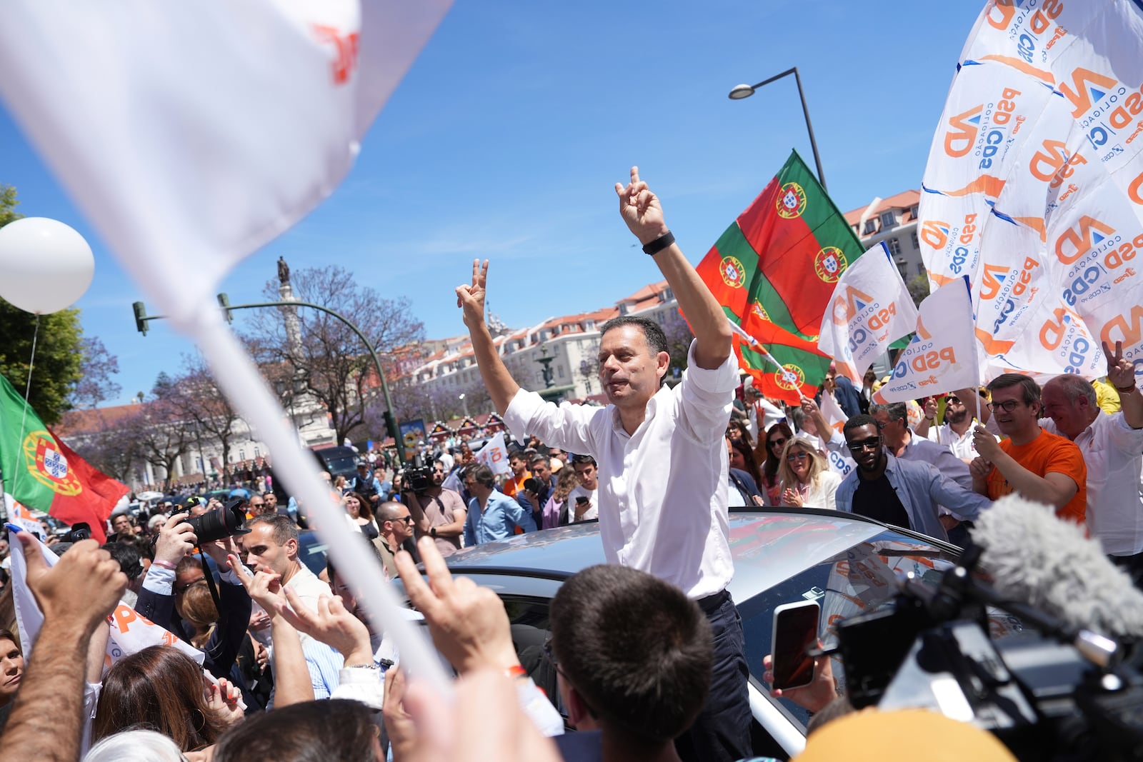 Incumbent Prime Minister and leader of the center-right Social Democratic Party Luis Montenegro gestures to supporters during an election campaign action in downtown Lisbon, Friday, May 16, 2025, ahead of the May 18 general election. (AP Photo/Ana Brigida)