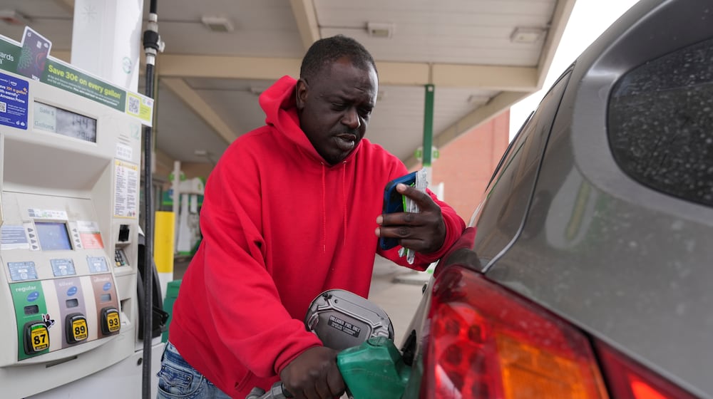Dave Thomas purchases gasoline at a station Tuesday, March 24, 2026, in Chicago. (AP Photo/Erin Hooley)
