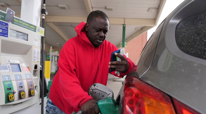 Dave Thomas purchases gasoline at a station Tuesday, March 24, 2026, in Chicago. (AP Photo/Erin Hooley)