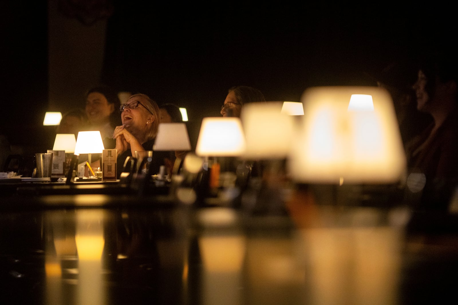Audience members laugh during Stand Up For Climate, a comedy show at Flappers Comedy on Thursday, March 20, 2025, in Burbank, Calif. (AP Photo/Ethan Swope)
