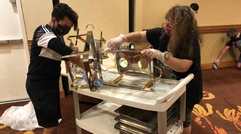 Cody Smith and Pam Smith deep clean items in the ball room of downtown Springfield’s Courtyard by Marriott as part of a volunteer effort on Saturday, May 23. Photo by Brett Turner
