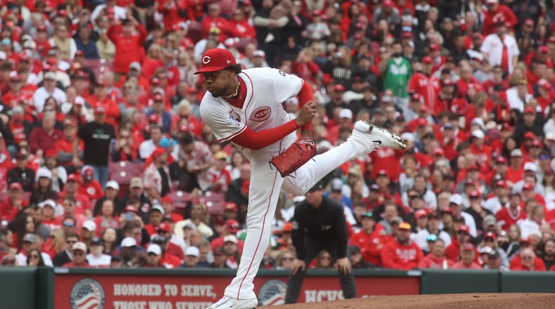 Reds starter Hunter Greene throws the first pitch of the season against the Giants on Thursday, March 27, 2025, on Opening Day at Great American Ball Park in Cincinnati. David Jablonski/Staff