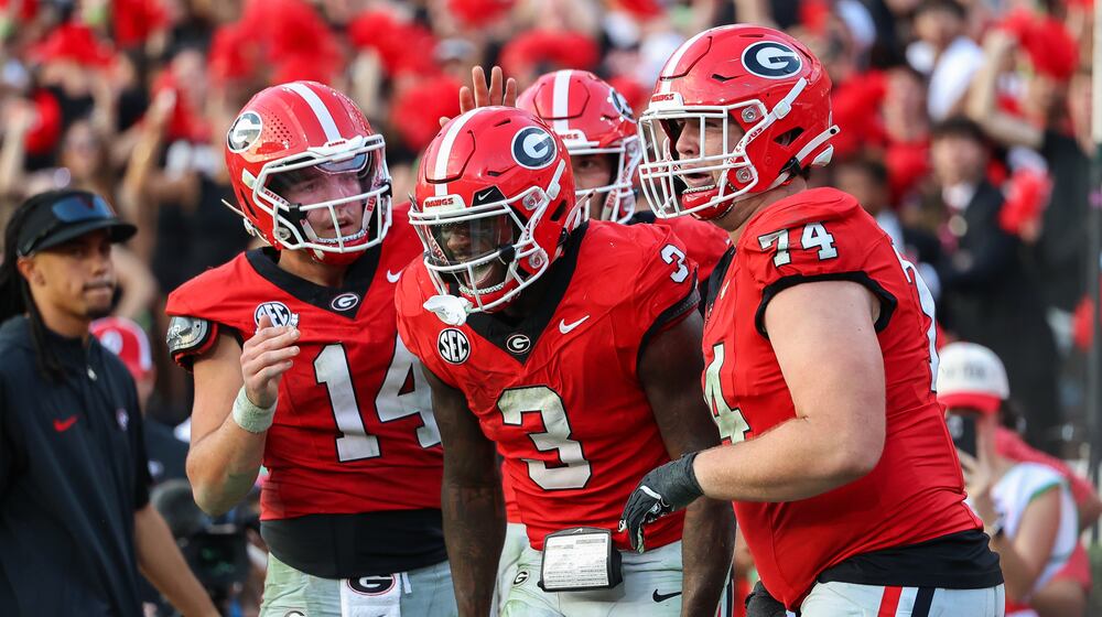 Georgia running back Nate Frazier (3) reacts with quarterback Gunner Stockton (14) and offensive lineman Drew Bobo (74) after scoring a touchdown during the second half of an NCAA college football game against Mississippi, Saturday, Oct. 18, 2025, in Athens, Ga. (AP Photo/Colin Hubbard)