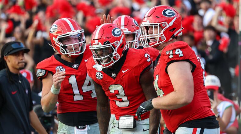 Georgia running back Nate Frazier (3) reacts with quarterback Gunner Stockton (14) and offensive lineman Drew Bobo (74) after scoring a touchdown during the second half of an NCAA college football game against Mississippi, Saturday, Oct. 18, 2025, in Athens, Ga. (AP Photo/Colin Hubbard)
