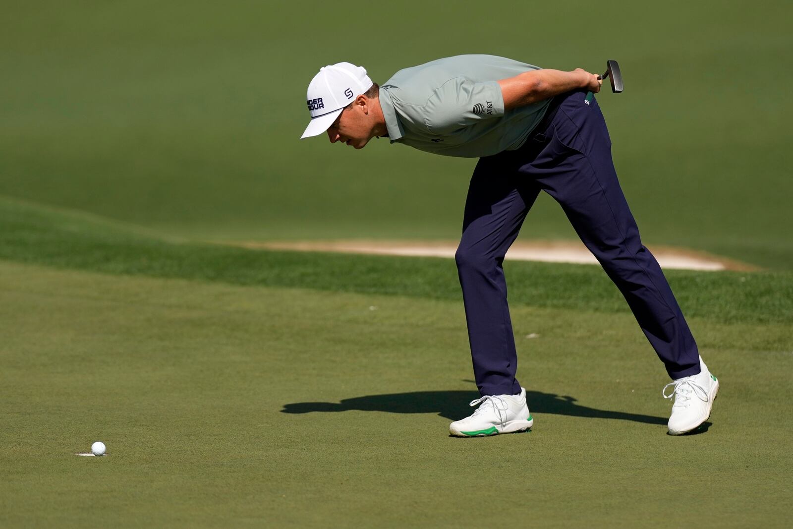 Jordan Spieth looks at Tom Kim's, of South Korea, ball rest on the edge of the cup on the second hole during the first round at the Masters golf tournament, Thursday, April 10, 2025, in Augusta, Ga. (AP Photo/George Walker IV)