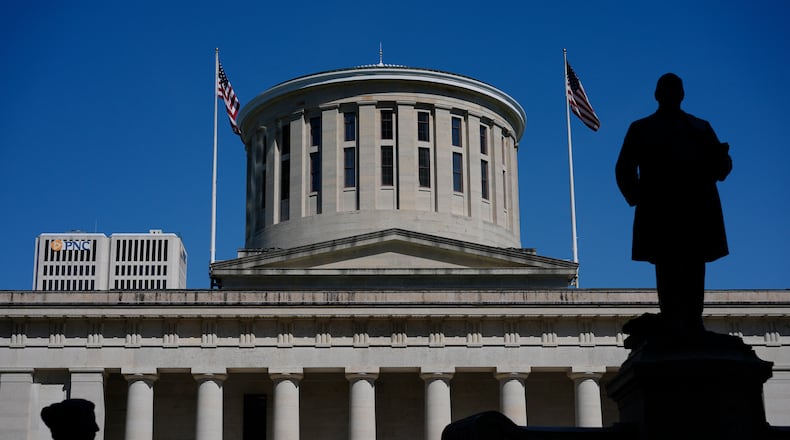 FILE - The William McKinley Monument is silhouetted in front of the west side of the Ohio Statehouse, Monday, April 15, 2024, in Columbus, Ohio. Republican legislative leaders in Ohio say they are negotiating with Democrats to assure President Joe Biden appears on the state's November ballot, but the exact shape of the solution remains murky. (AP Photo/Carolyn Kaster, File)